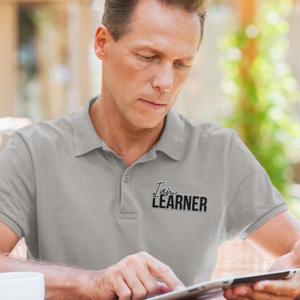 man wearing grey color polo tshirt printed quote "I'm Learner"